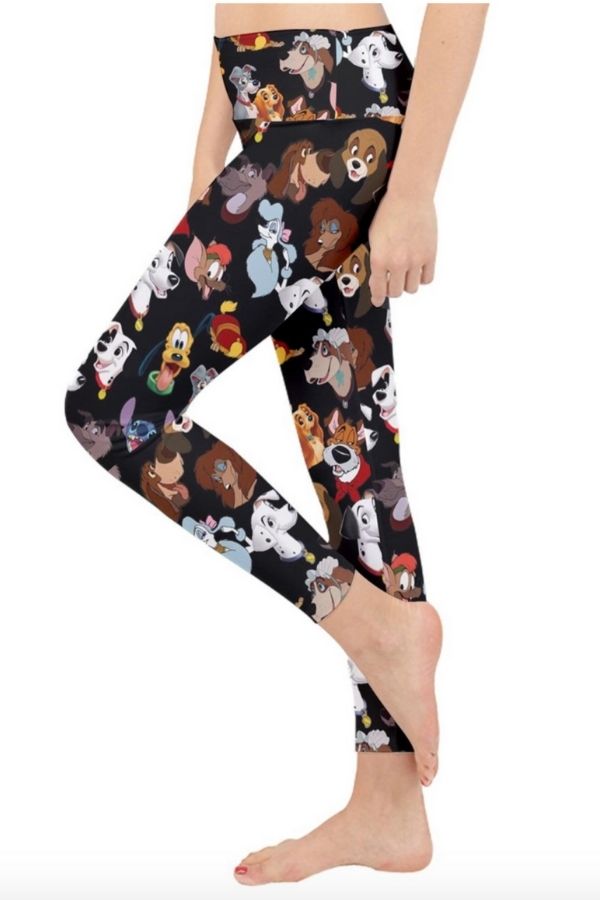 a black pair of leggings featuring the heads of various dogs from Disney movies and shows