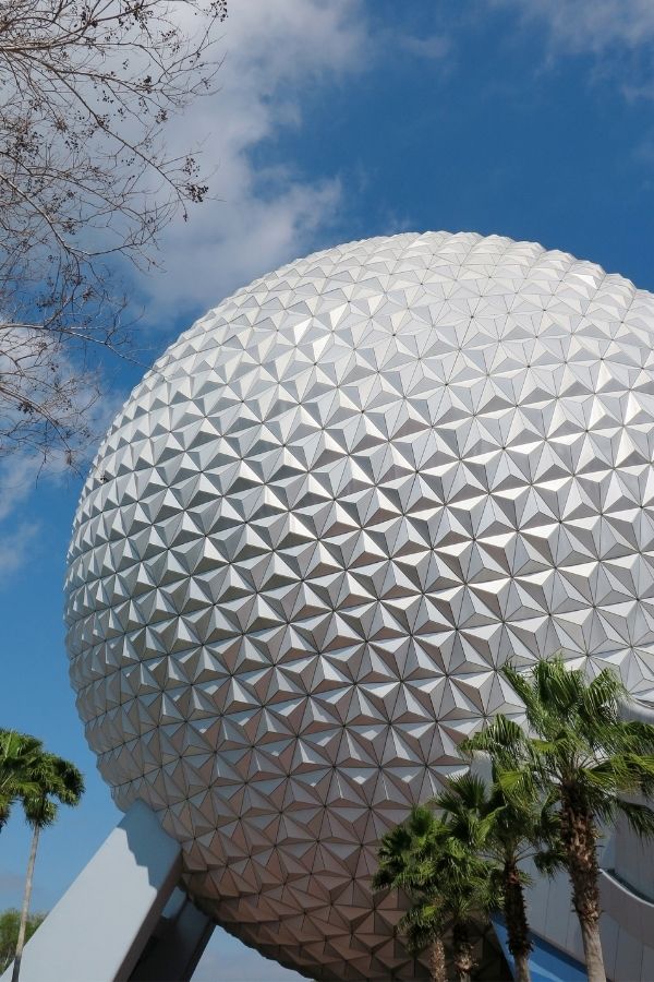 Spaceship Earth flanked by palm trees at Epcot in Walt Disney World