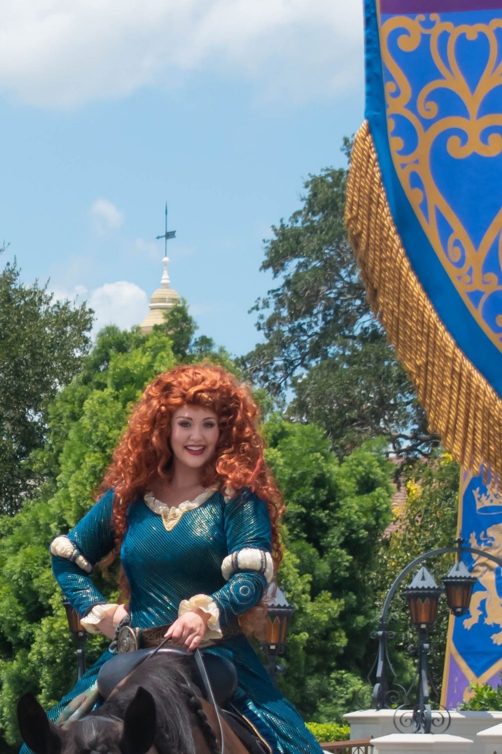 Merida, from the Disney Princess movie Brave, rides a horse at Disney World