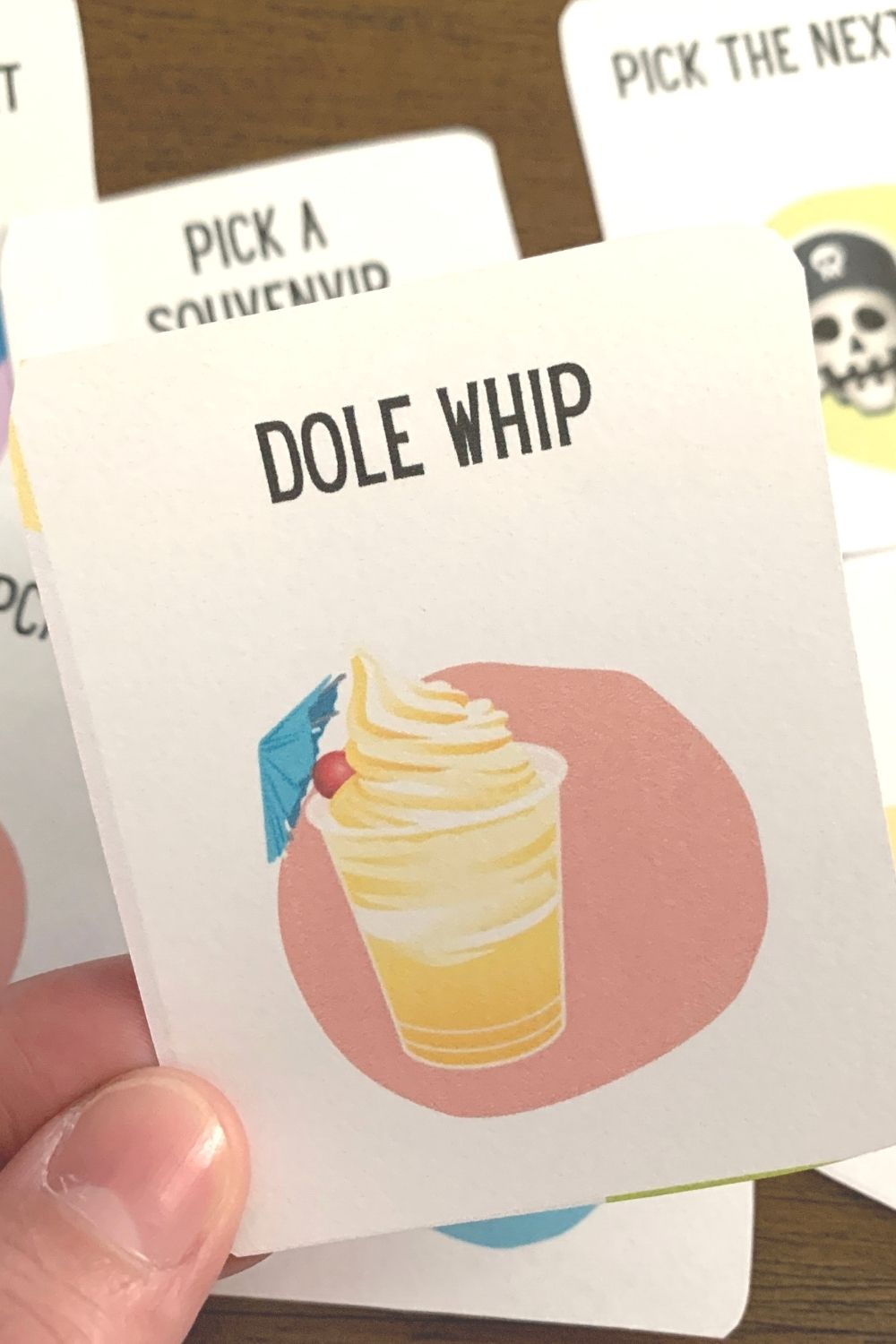 a hand holding one of the printable Disney coupons for kids, which kids can redeem to their parents for a Dole Whip