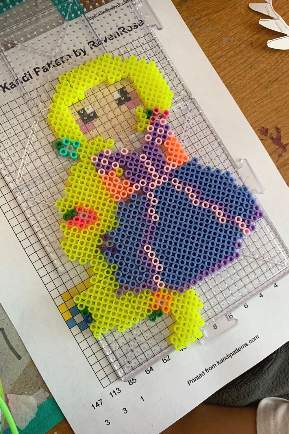 Rapunzel Perler bead design being constructed over a pattern for the Disney Princess
