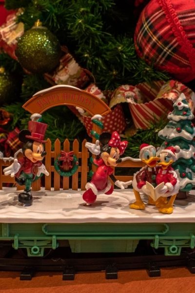 Mickey Christmas train circles around a Christmas tree