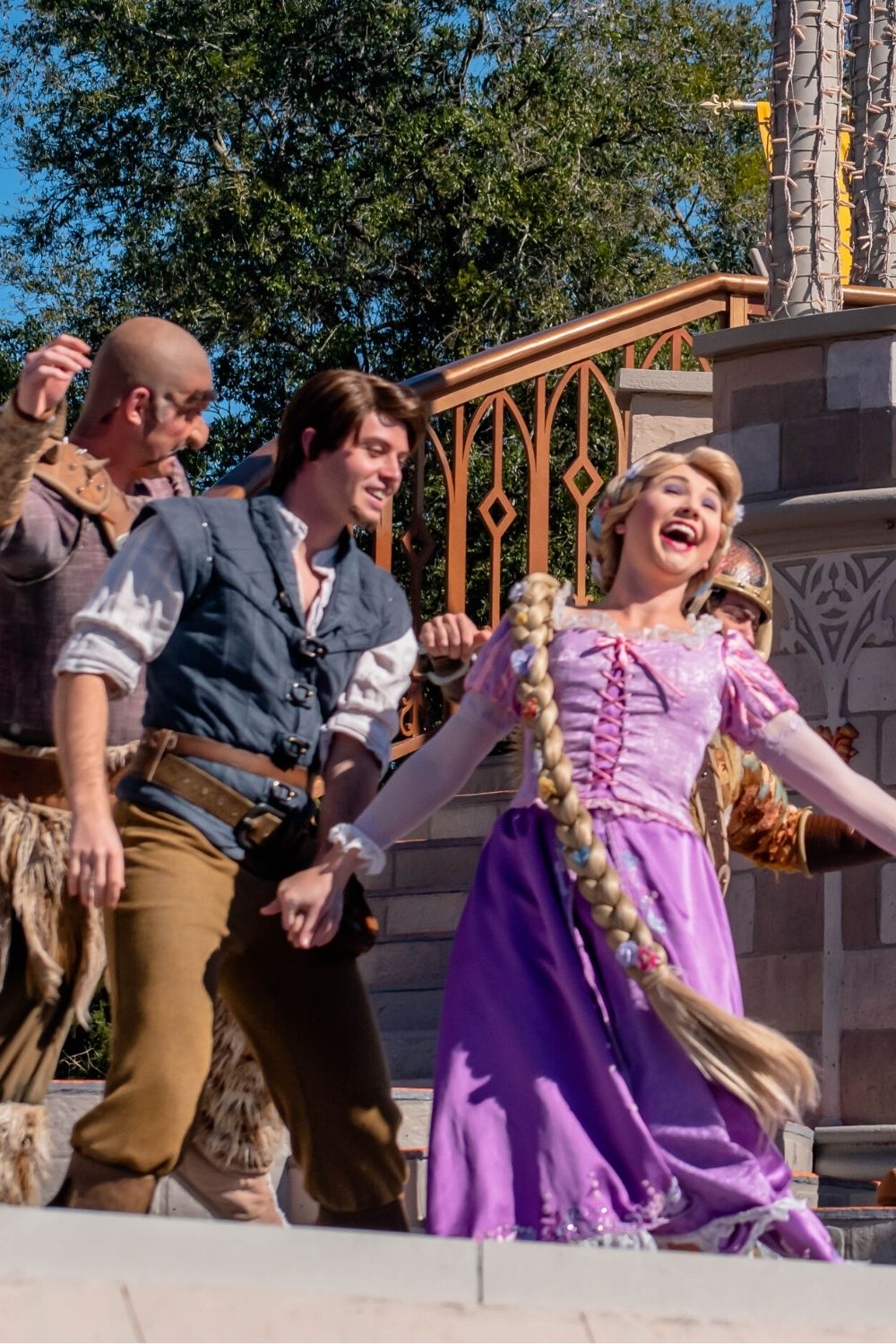 Princess Rapunzel dances with Flynn Rider on a stage show at Disney World