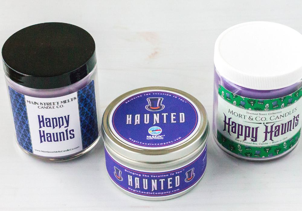 three candles inspired by Disney's Haunted Mansion: one from Main Street Melts, one from Magic Candle Company, and one from Mort and Co. Candles.