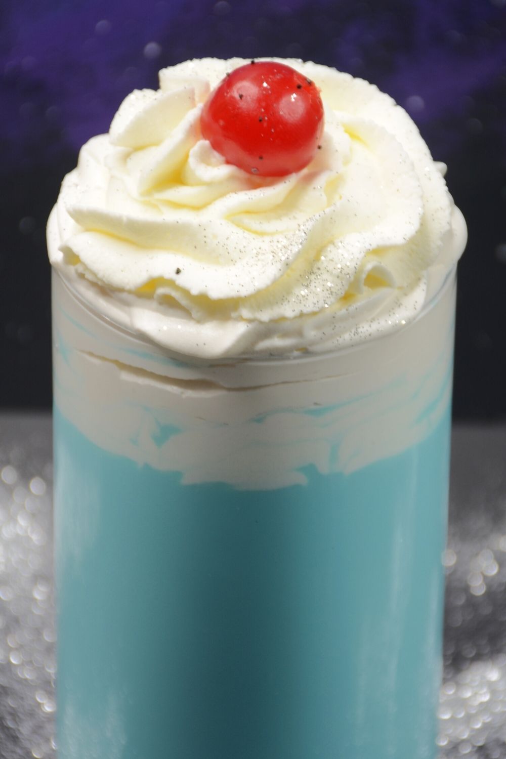 Frosty Star Wars blue milk topped with whipped cream, sugar, and a cherry