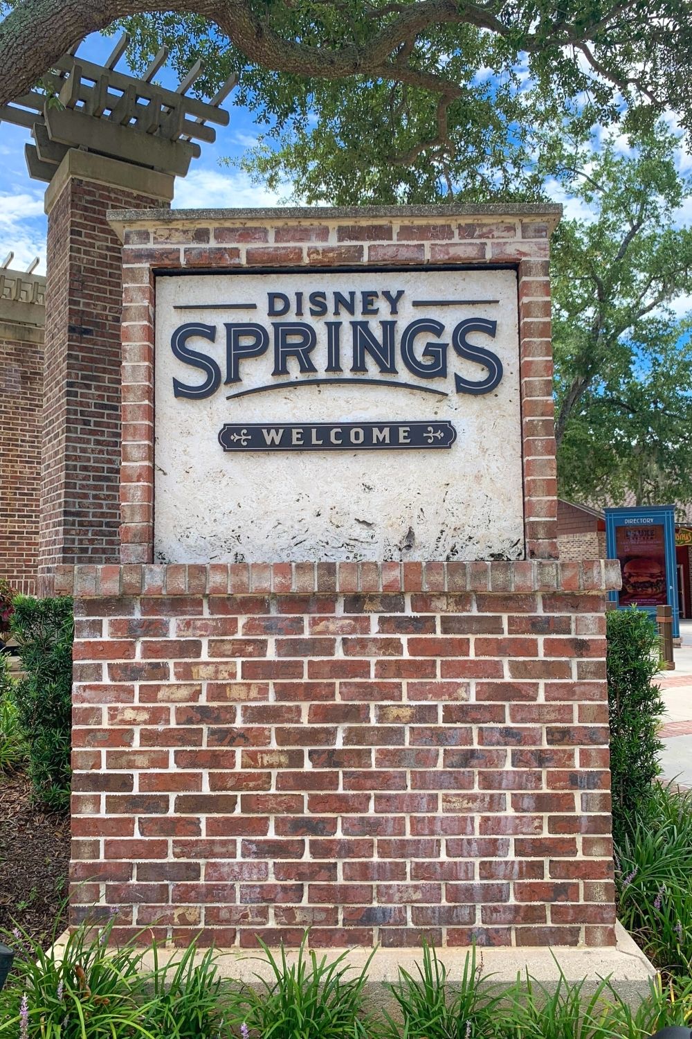 the brick welcome sign at Disney Springs