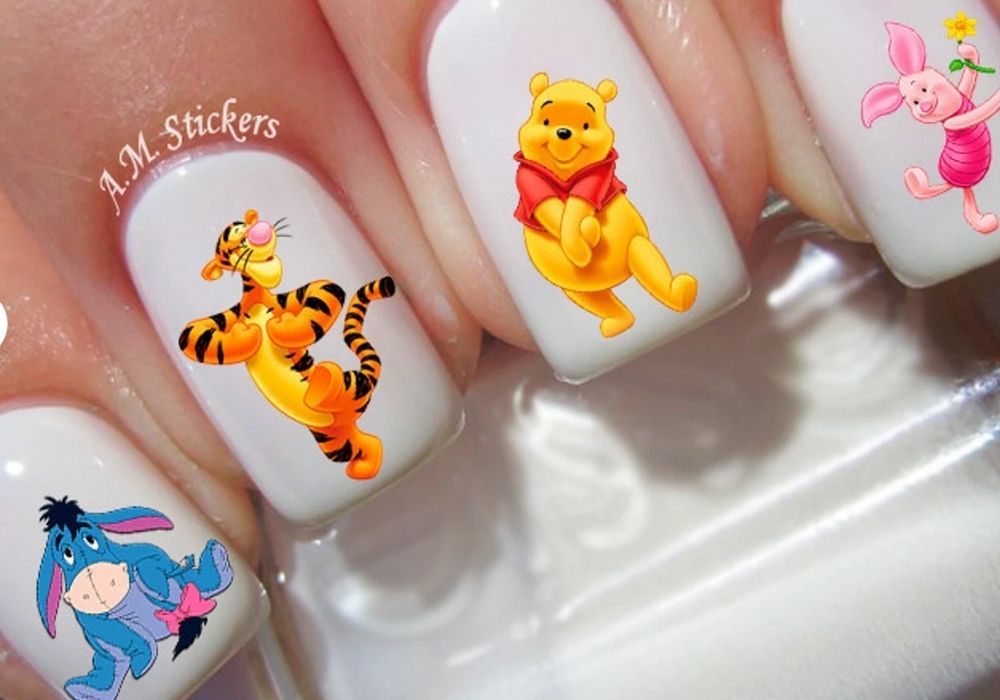 Disney nail art featuring stickers of Winnie the Pooh and friends