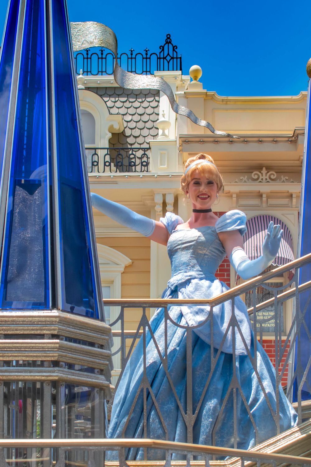 Cinderella waves from a parade float at Disney World