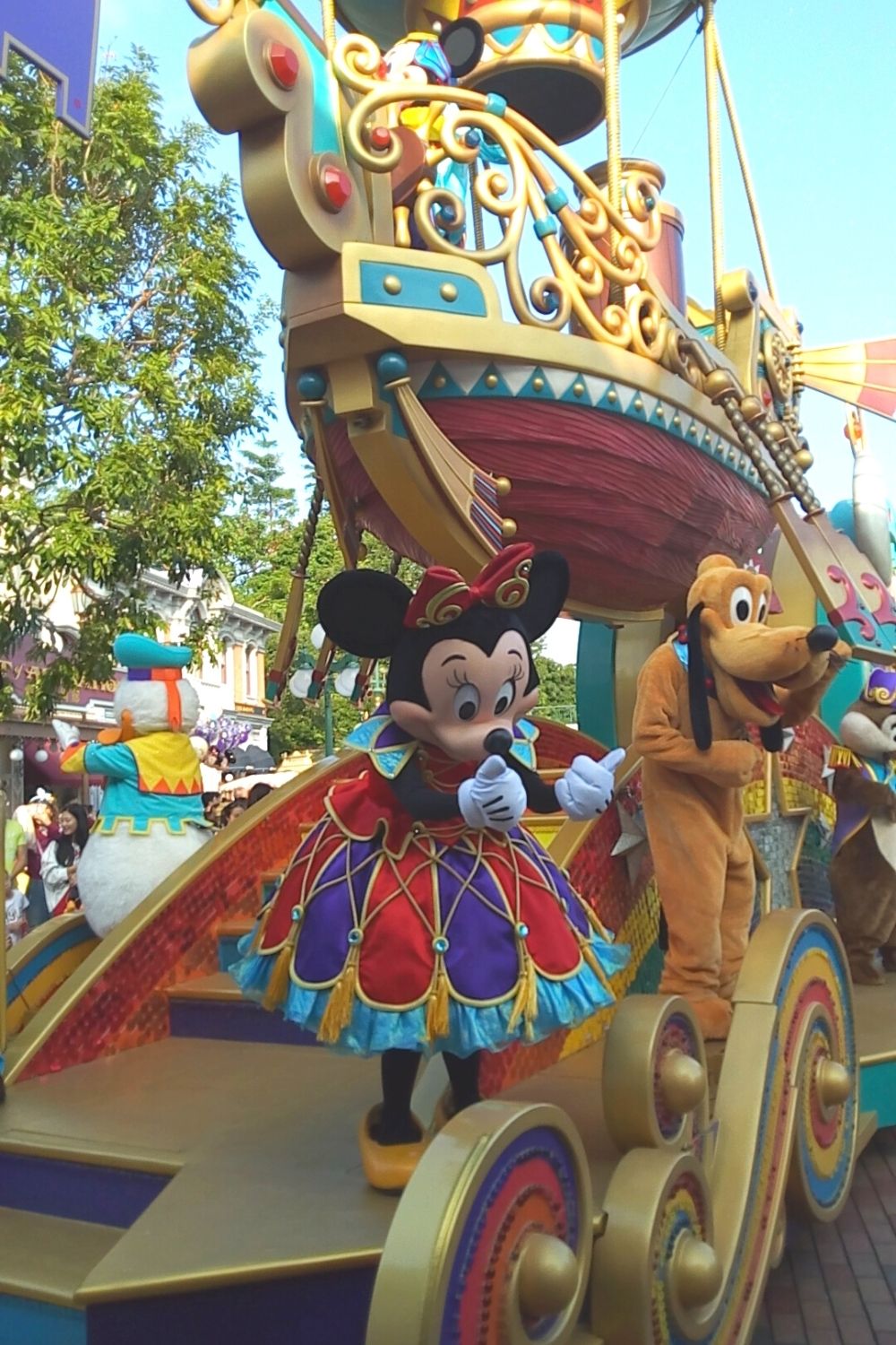 Minnie Mouse and Pluto on a parade float at Disney's theme park