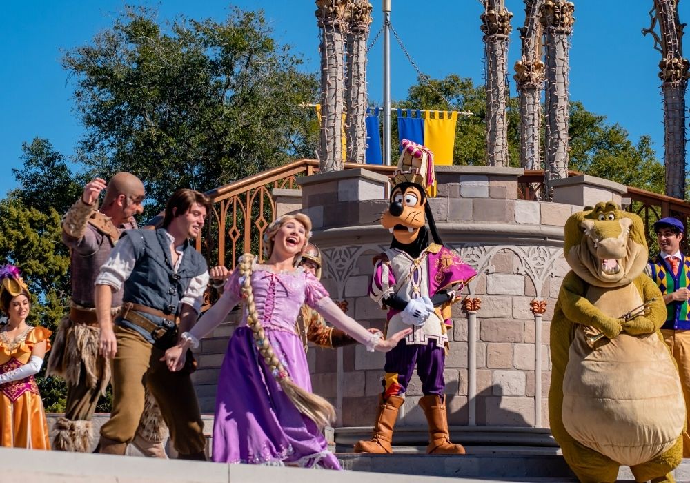 Rapunzel, Goofy, and other characters performing in a stage show at Magic Kingdom in Walt Disney World