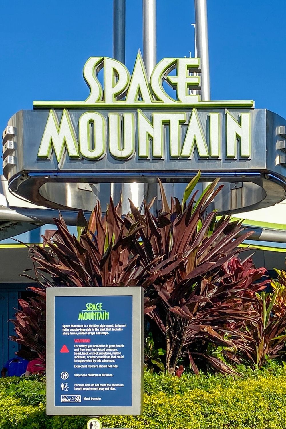 a sign posted outside of Space Mountain at Disney World gives a warning about who should not ride the attraction, what the height requirements are, etc.