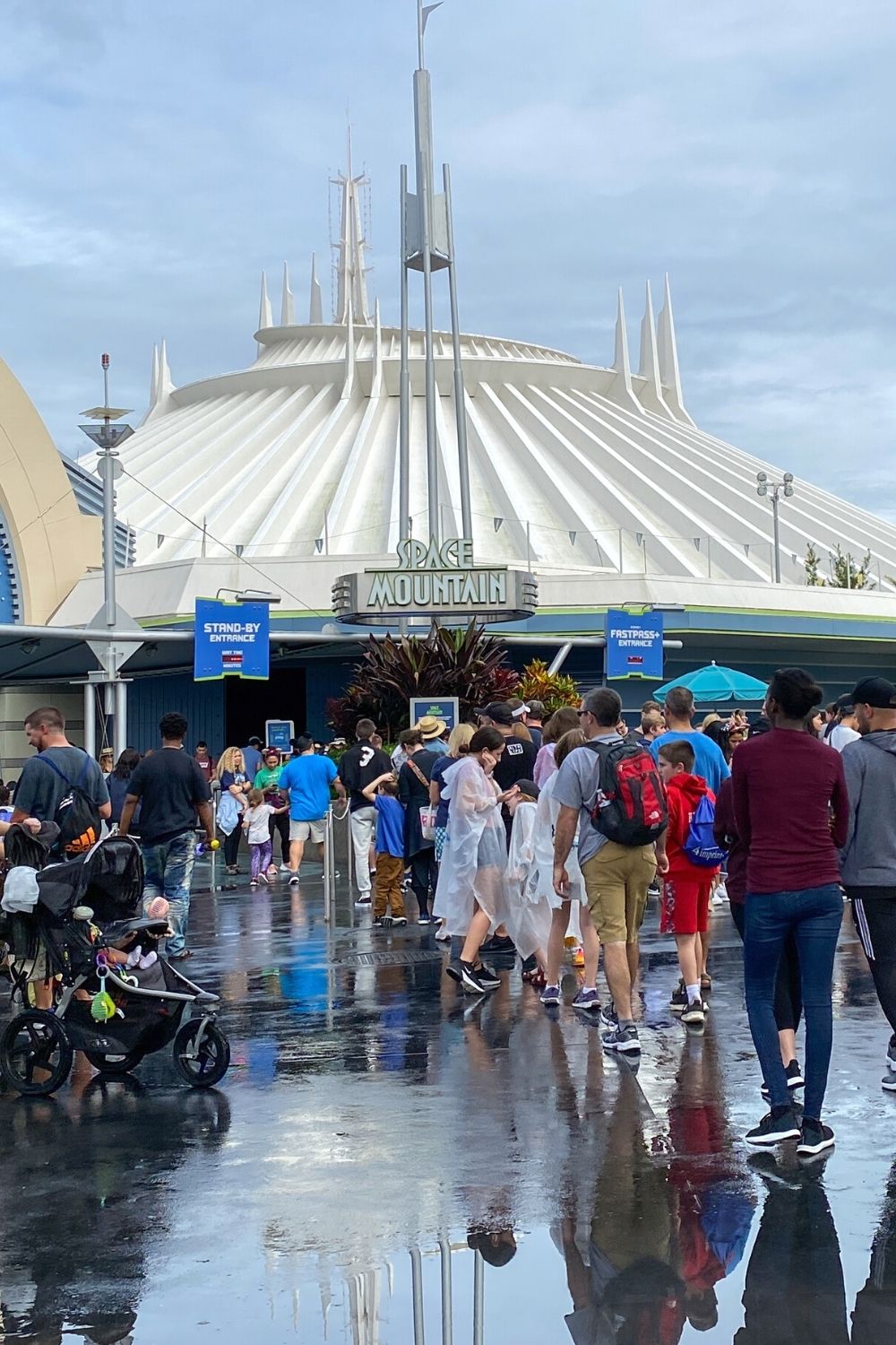 Disney guests wait in a queue outside of Space Mountain in Tomorrowland at Magic Kingdom