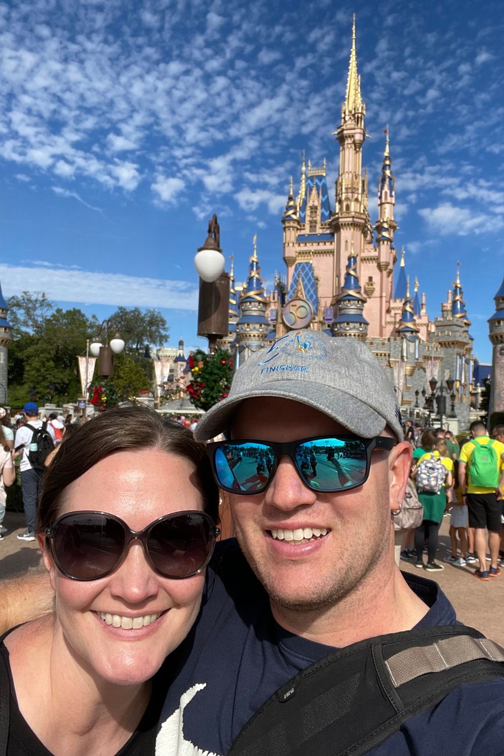 the owner of Magical Adventure Guide, Chrysti, with her husband at Disney World's Magic Kingdom.